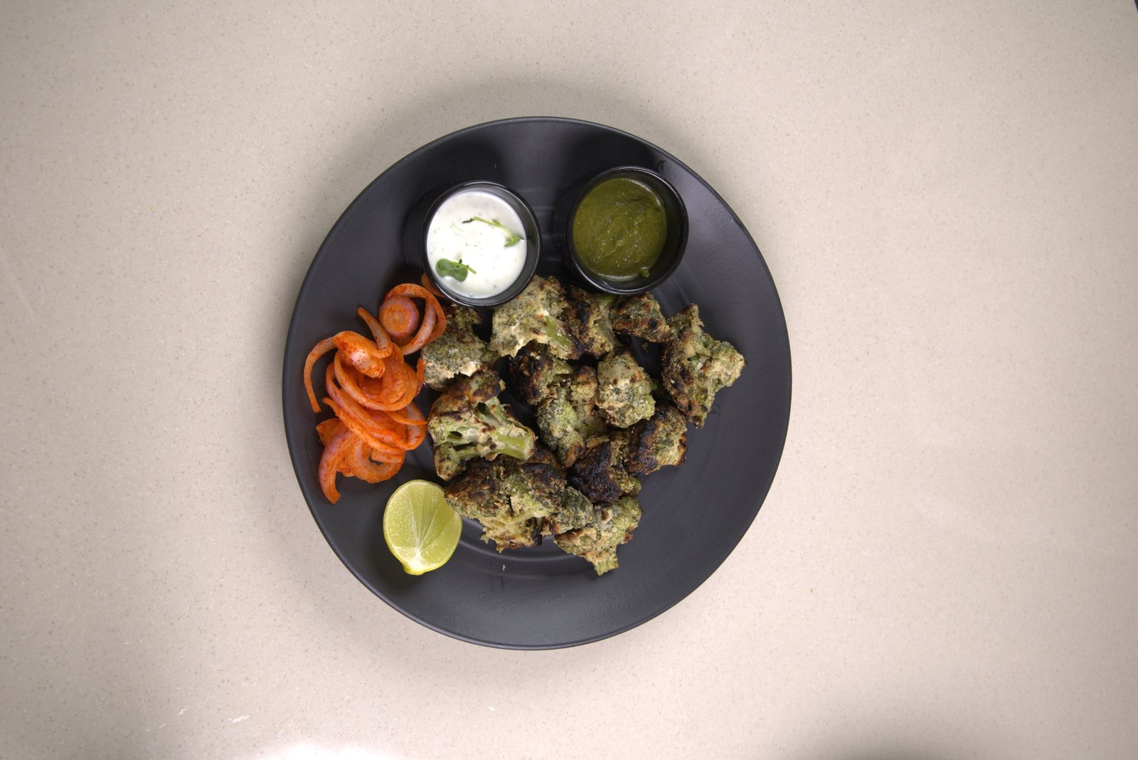 Malai broccoli, char-grilled, served with mint and coriander dips
