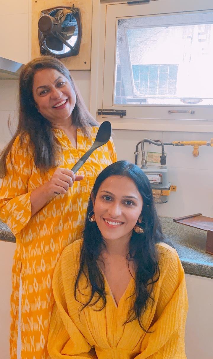 Mom and Nidhi being playful in the kitchen