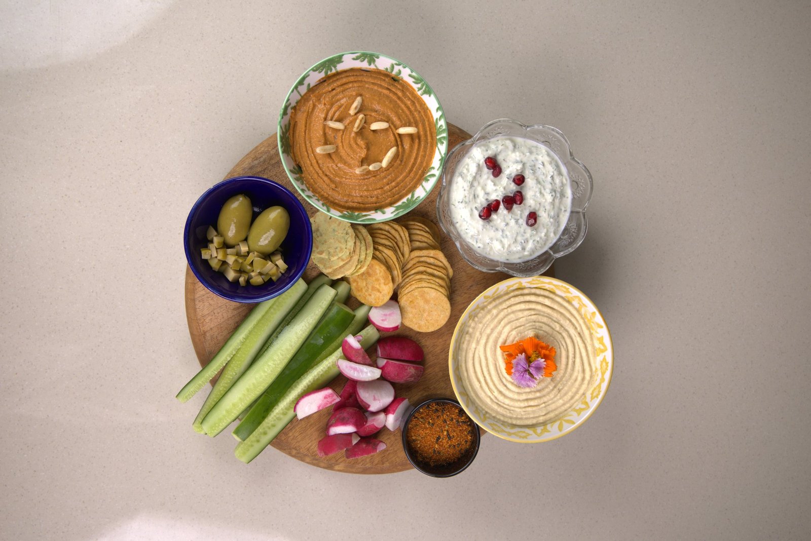 An abundant mezze spread of hummus, dips, breads and fresh bites